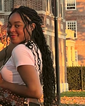 Chioma, founder of Mrs. Clean Detroit, outdoors at golden hour, tighter upper-body crop